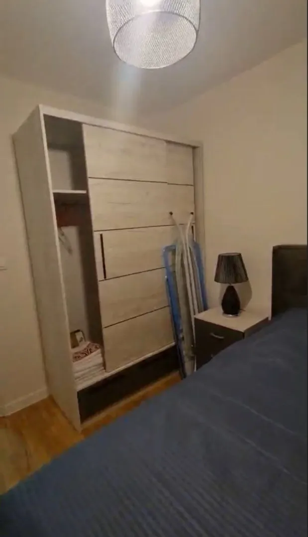 Furnished bedroom with a wardrobe and a double bed.