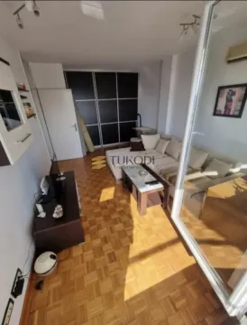 Living room with sofa, coffee table and parquet flooring. - image 2