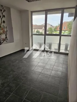 Empty room with dark floor tiles and a large window. - image 3