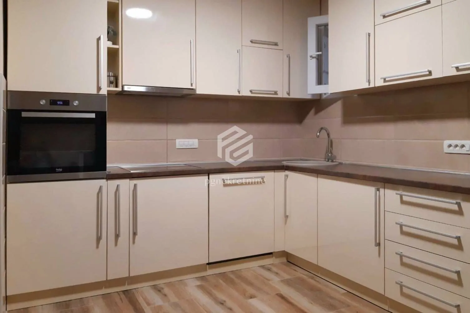 Corner kitchen with built-in cabinetry and appliances.