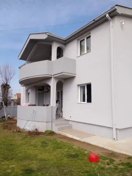 Exterior view of a two-story house with a balcony and yard. - image 8