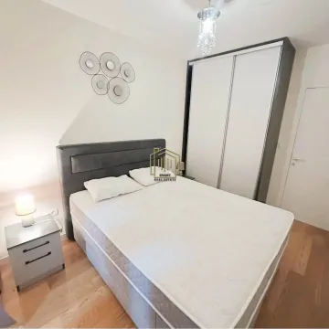 Furnished bedroom with a double bed, wardrobe, and nightstand. - image 6