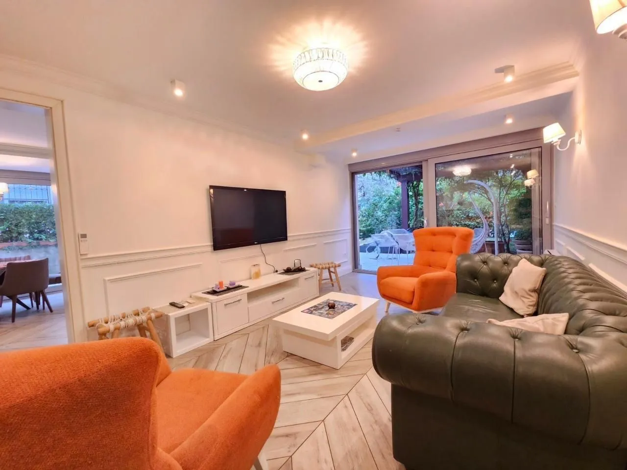 Spacious living room with sofa set and access to the yard.