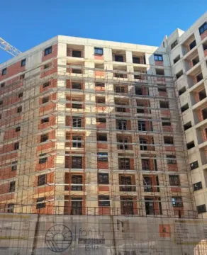 View of a multi-family residential building under construction with scaffolding on the facade. - image 2