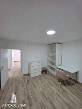 Small room with a white desk, shelves, and a chest of drawers. - image 12