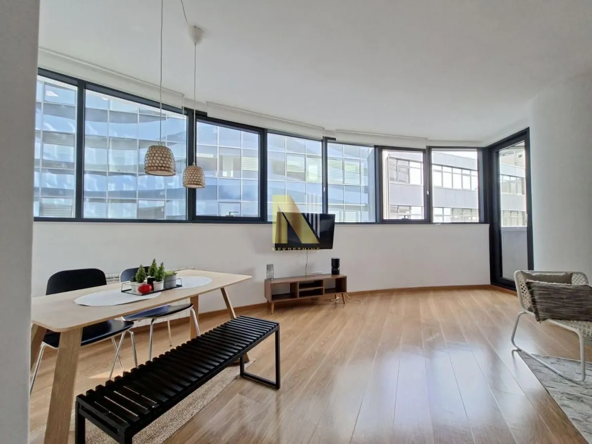 Spacious living room with a dining area and large windows.