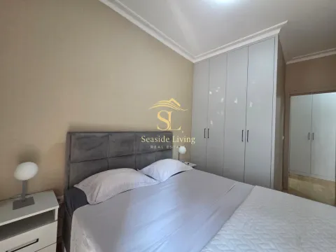 Furnished bedroom with a double bed, wardrobe, and bedside tables. - image 8