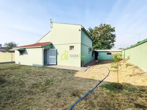 View of the back of the house with a yard. - image 2