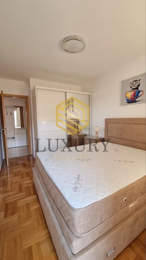 Furnished bedroom with a double bed and wardrobe.