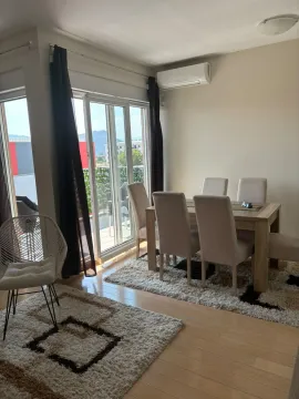 Dining area with a table, chairs, and access to the terrace. - image 4