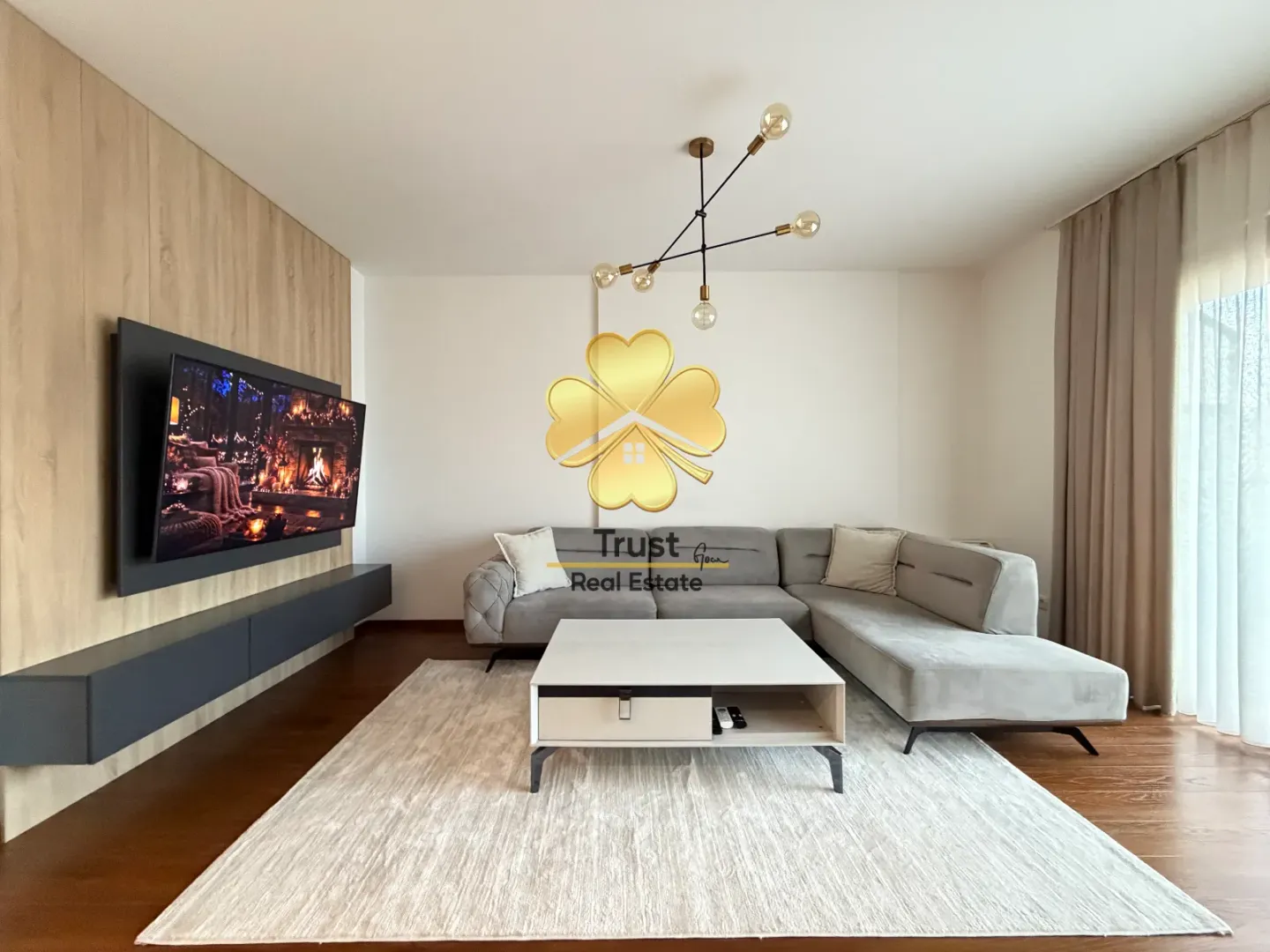 Modern and bright living room with a sofa and TV.