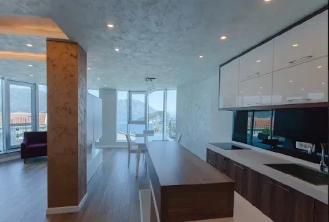 Modern kitchen with a bar counter and dining area in an open space with a sea view. - image 8