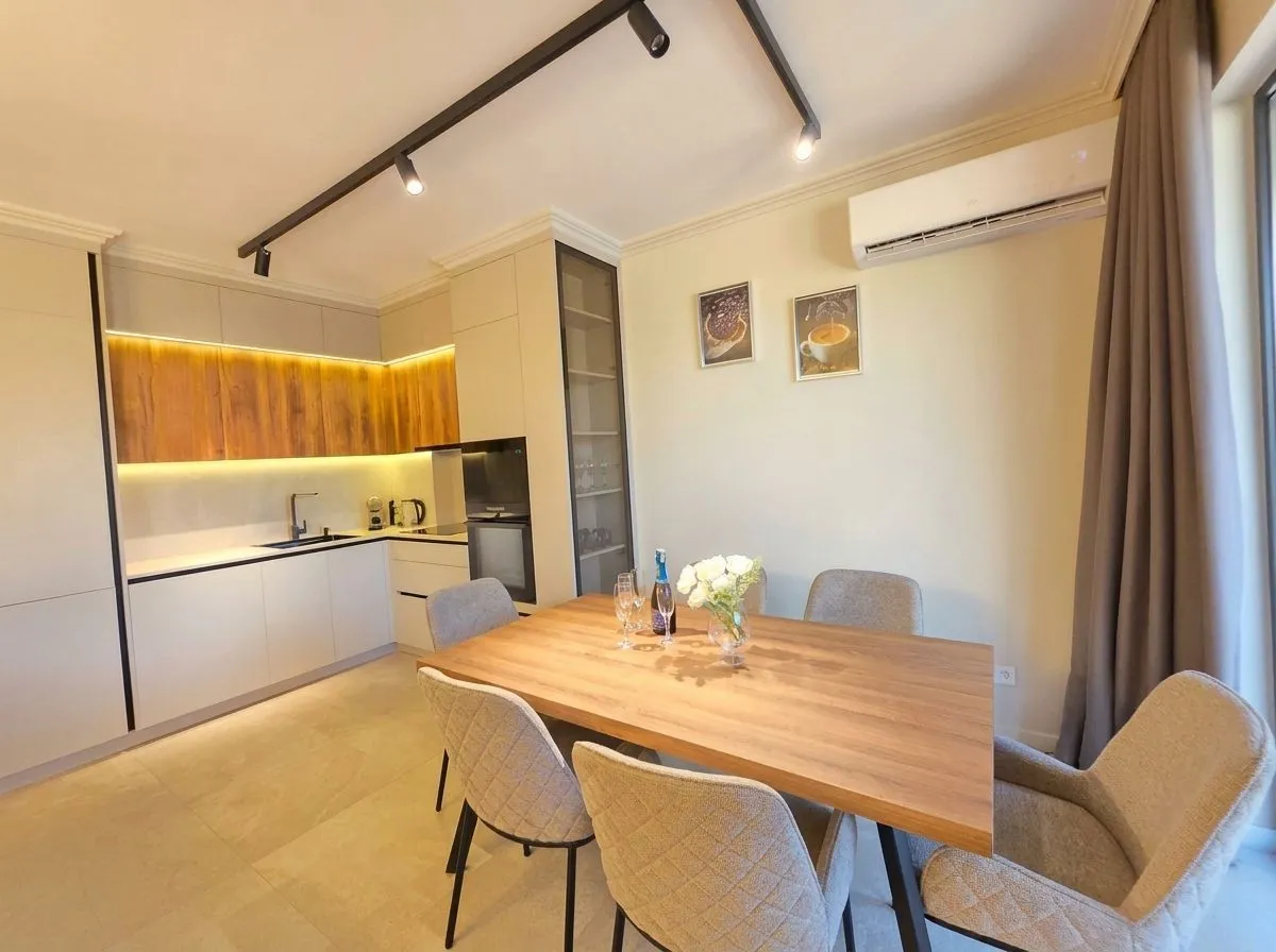 Modern kitchen with a dining table and chairs.