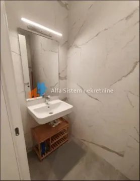 Small tiled bathroom with a washbasin and a mirror. - image 15