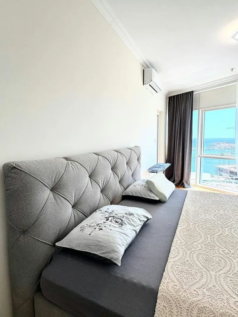 Bedroom with a large double bed and a sea view.