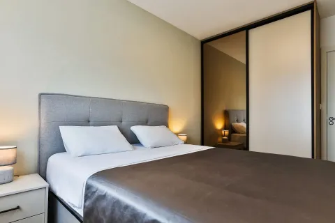 Furnished bedroom with a double bed and a fitted wardrobe. - image 12