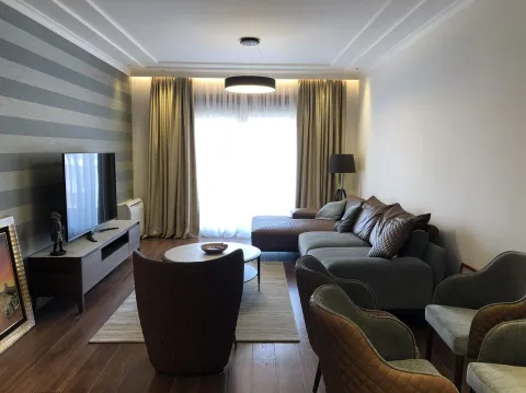 Living room with a sectional sofa and TV. - image 4