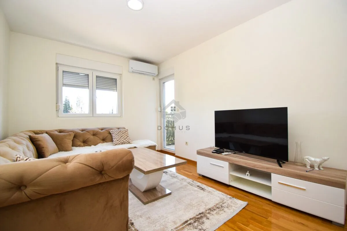 Living room with a sectional sofa, coffee table, and TV.