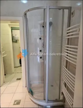 Bathroom with a shower cabin and a towel radiator. - image 9