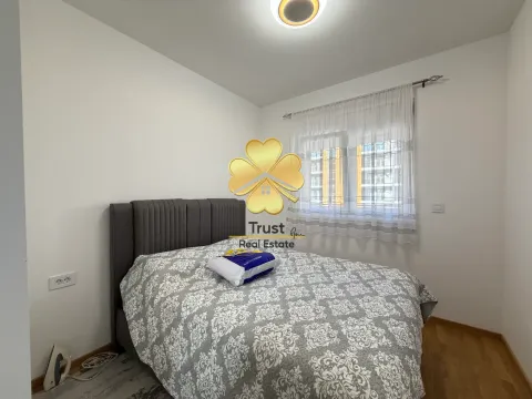 Furnished bedroom with a double bed and a window. - image 12