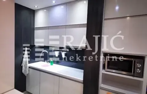 Modern kitchen with a sink and built-in appliances. - image 5