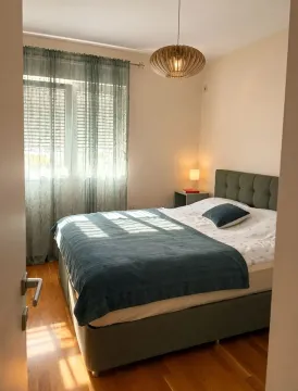 Furnished bedroom with a double bed and a window. - image 5