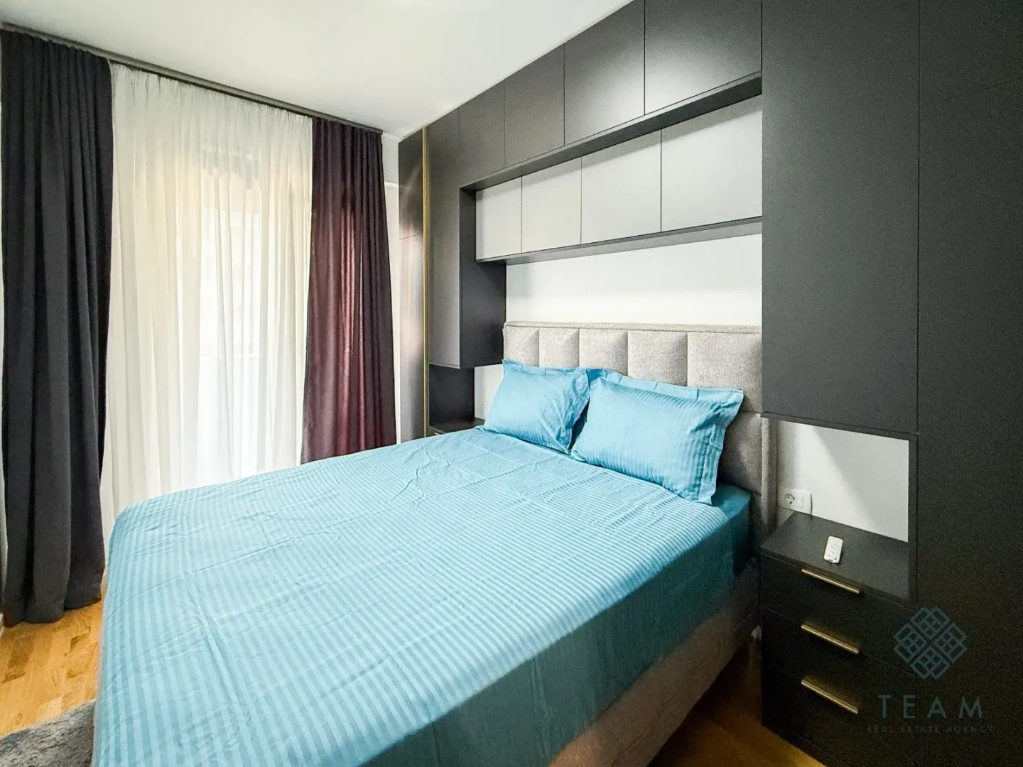 Furnished bedroom with a double bed and fitted wardrobes.