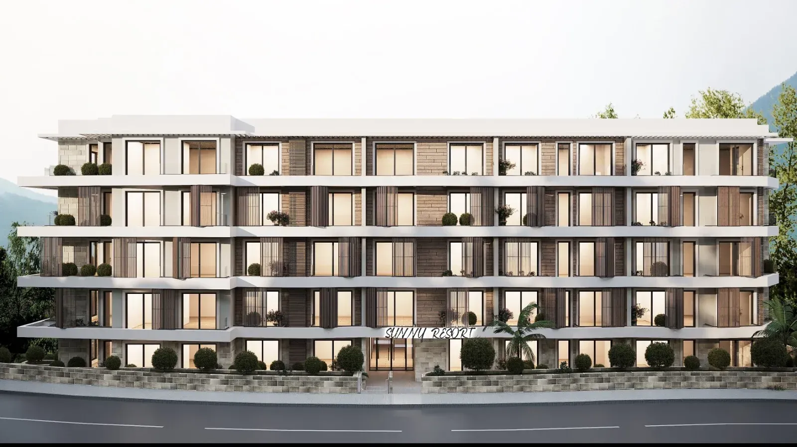 Front view of a modern residential building with terraces and a landscaped courtyard.