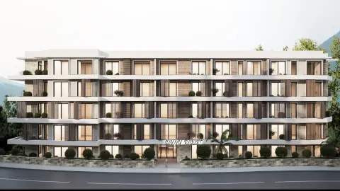 Front view of a modern residential building with terraces and a landscaped courtyard. - image 2