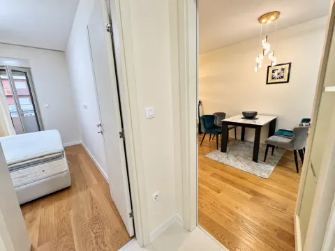 View from the hallway into the dining area and bedroom of the apartment. - image 10