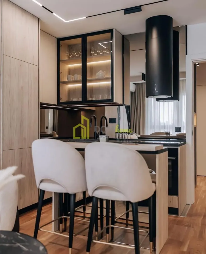Modern kitchen with a breakfast bar and bar stools.