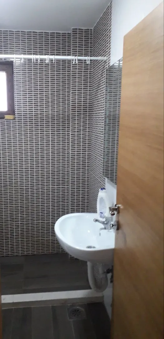 Small bathroom with a white sink and patterned tiles.