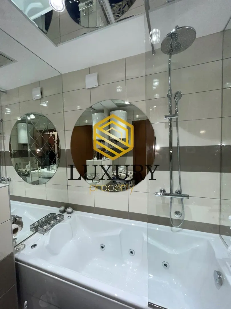 Modern bathroom with a hydromassage bathtub and a walk-in shower.