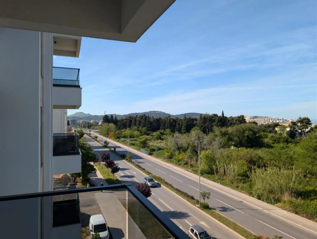 Pogled sa terase na okolnu ulicu i zelenilo.