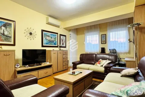 Living room with seating furniture, television, and wooden furniture. - image 2