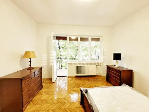 Furnished bedroom with wooden flooring and access to the terrace. - image 14