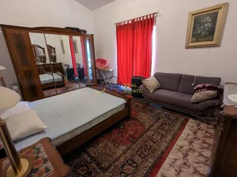Furnished bedroom with a large double bed, mirrored wardrobe, and a sofa. - image 13