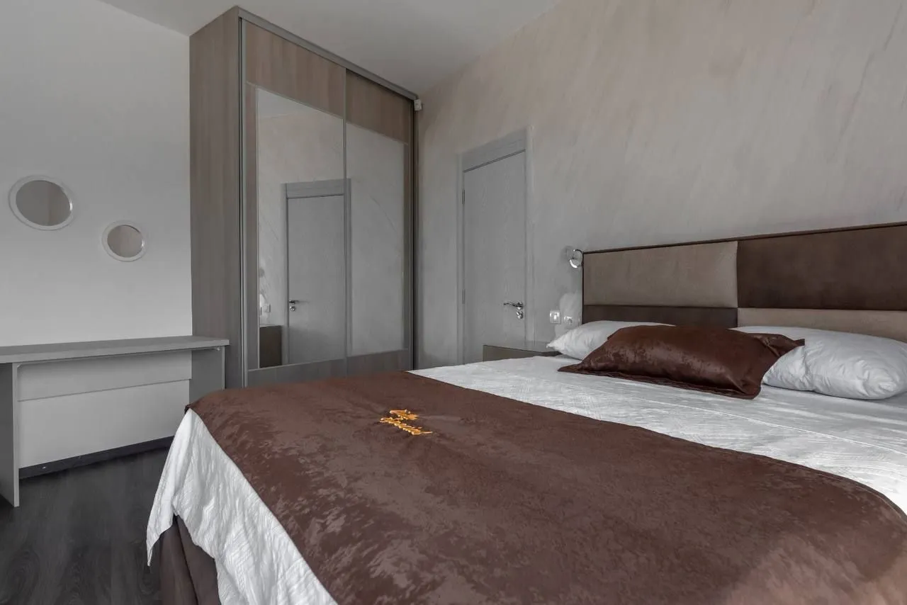 Furnished bedroom with a double bed, wardrobe, and a desk.