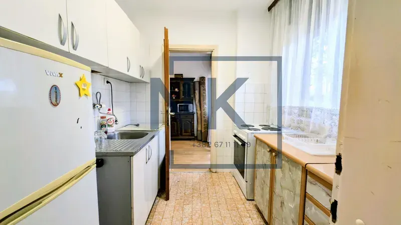 Small kitchen with a sink, stove, and refrigerator.