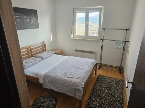 Furnished bedroom with a double bed, window, and a view of the surroundings. - image 5
