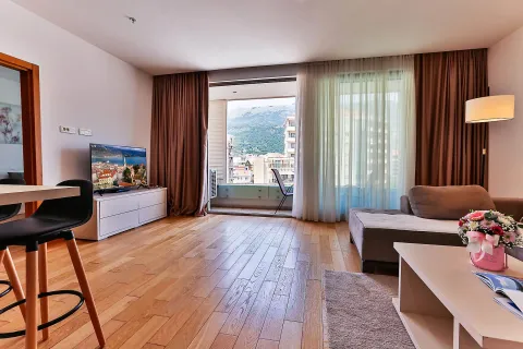 Prostrana dnevna soba sa garniturom, drvenim podom i izlazom na terasu. - image 8