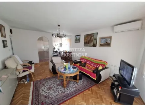 Living room with seating furniture and dining area in the background. - image 8