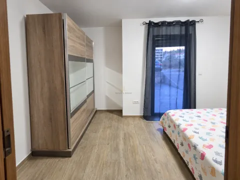 Bedroom with a double bed, large wooden wardrobe, and access to the terrace. - image 4