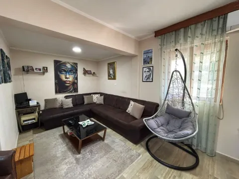 Living room with a sectional sofa, coffee table, and a hanging chair. - image 3
