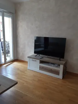 Living room with a TV on a stand. - image 14