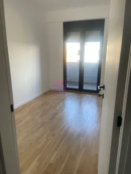 Empty room with wooden flooring and balcony access. - image 3