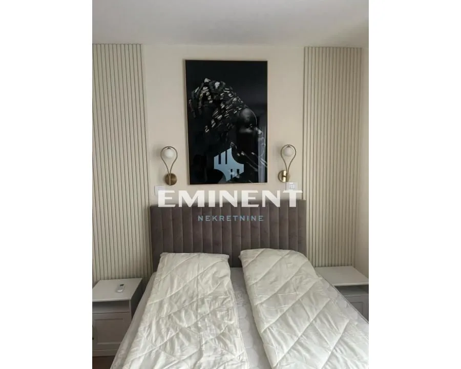 Bedroom with a double bed and decorative wall panels.