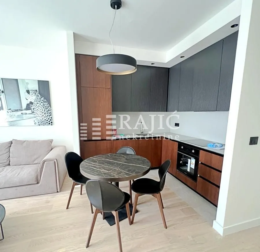 Modern living room with dining area and fitted kitchen.