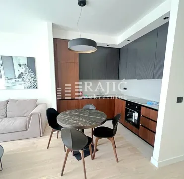 Modern living room with dining area and fitted kitchen. - image 4