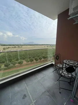 Balcony with a seating set and an open view of the countryside. - image 3